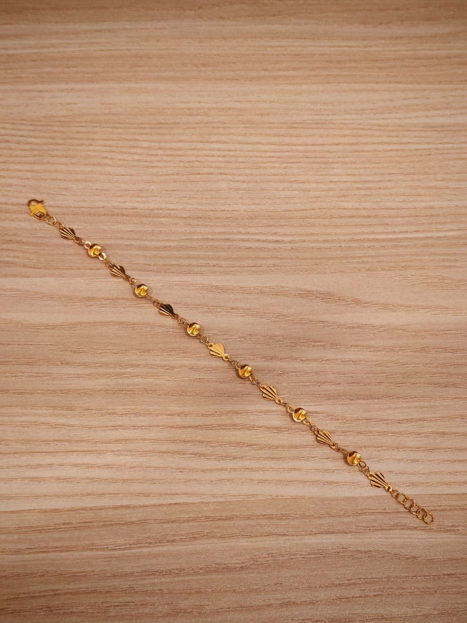 Gold bracelet with shell and ball details