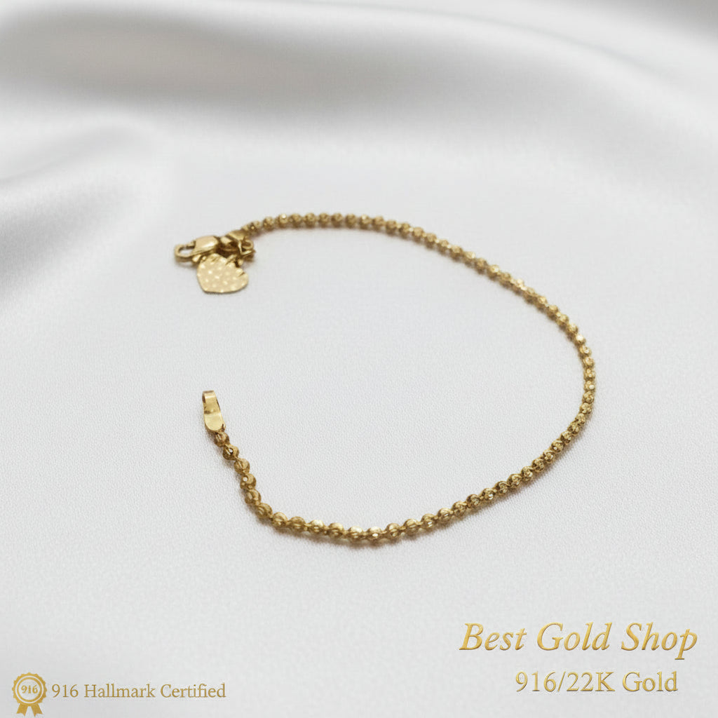 Close-up of heart charm on a 22K Gold solid bead bracelet.