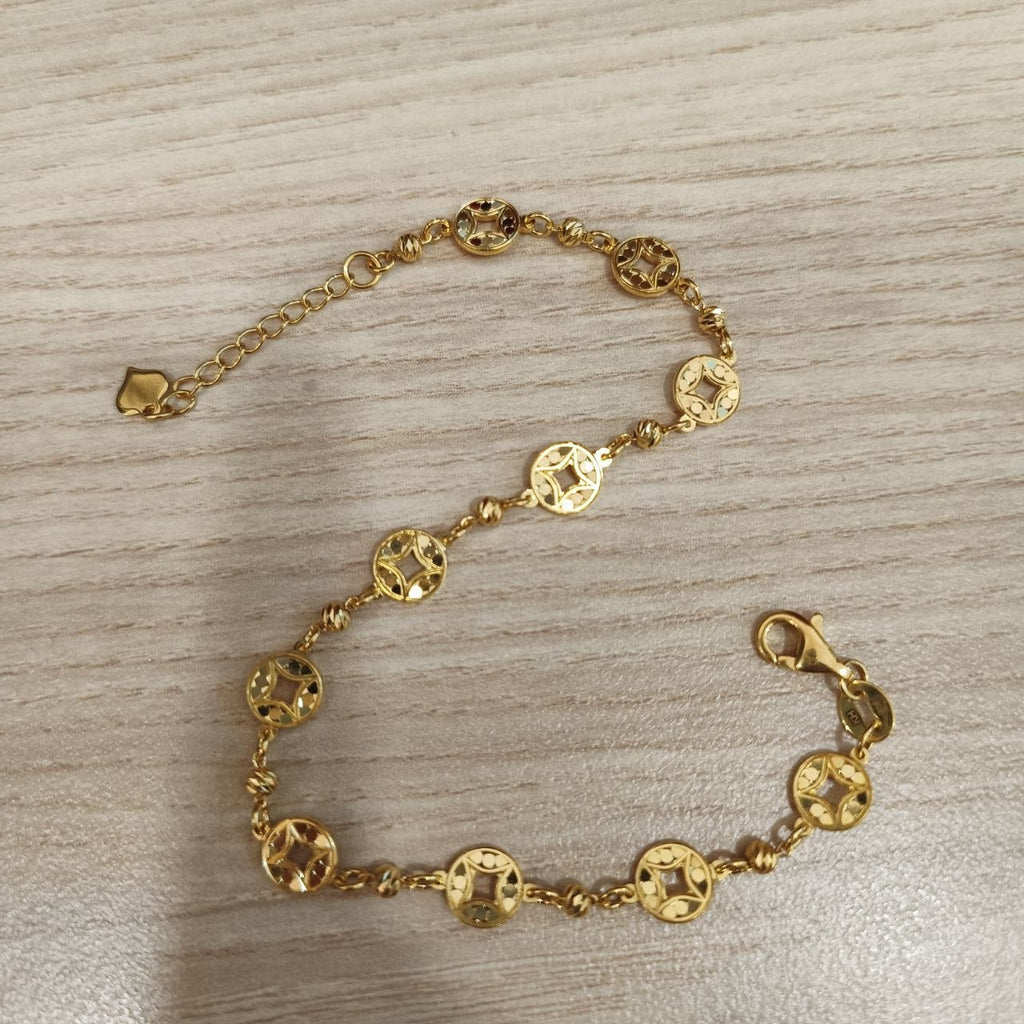 Adjustable 916 gold round motif bracelet laid open