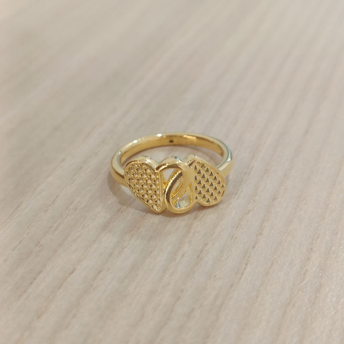 Angled front view of 916 gold cross heart ring