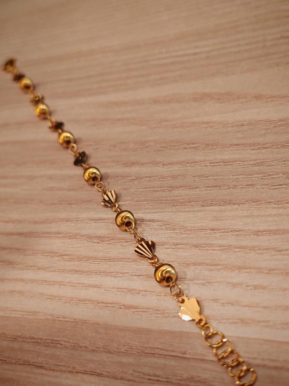 Fancy shell and polished ball stations on 916 gold bracelet