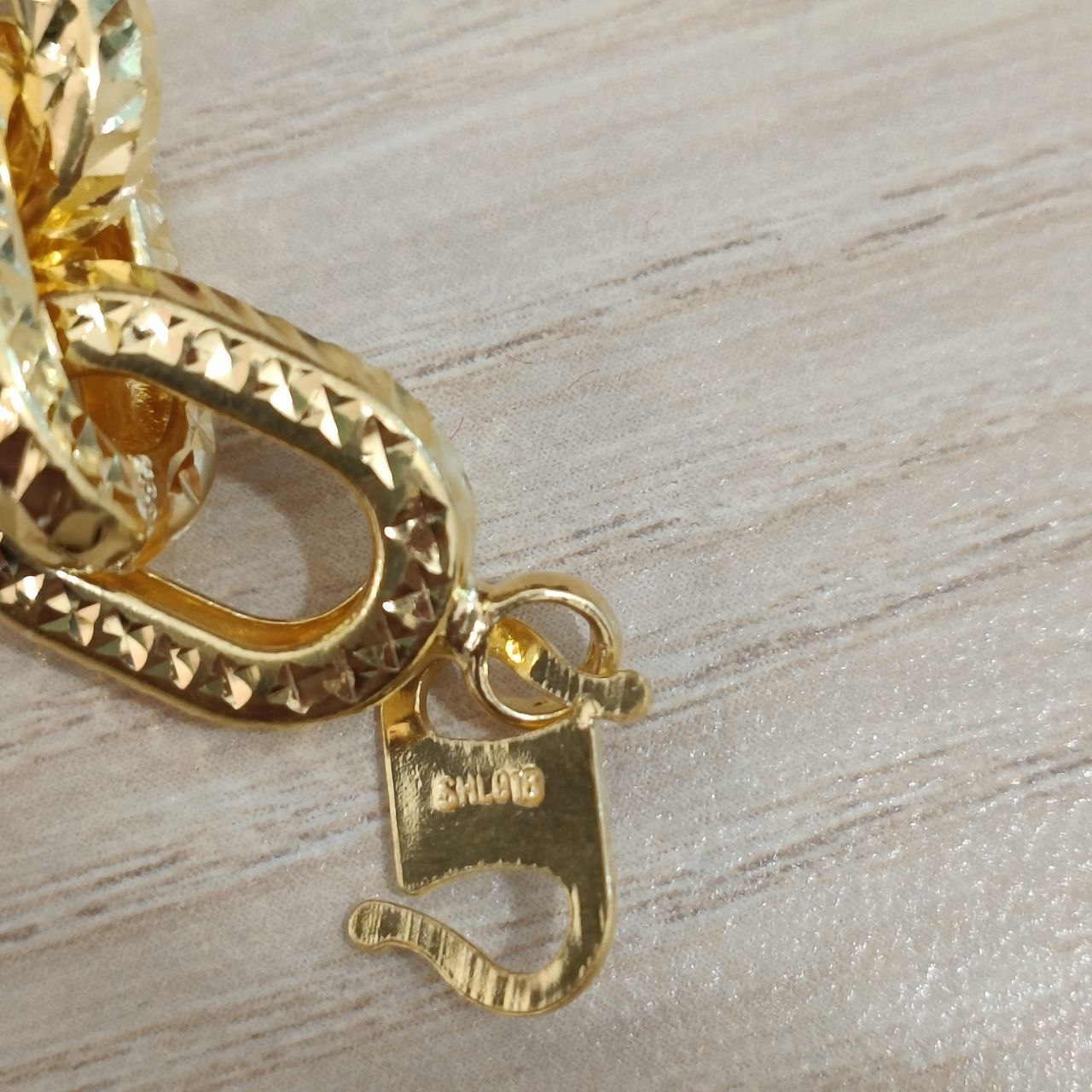 Full view of 916 gold hollow anchor link bracelet