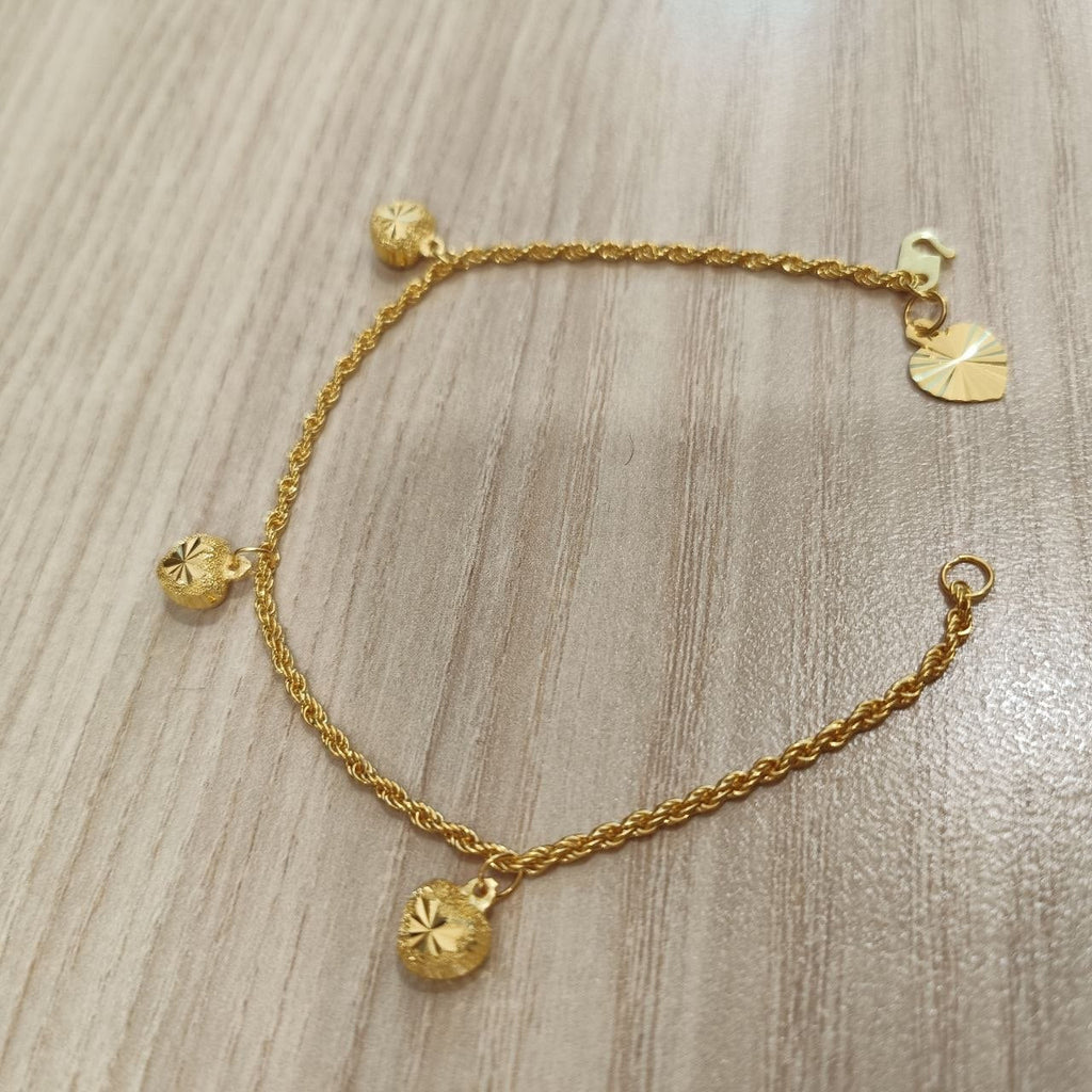 916 Gold hollow rope bracelet and heart charms angled view