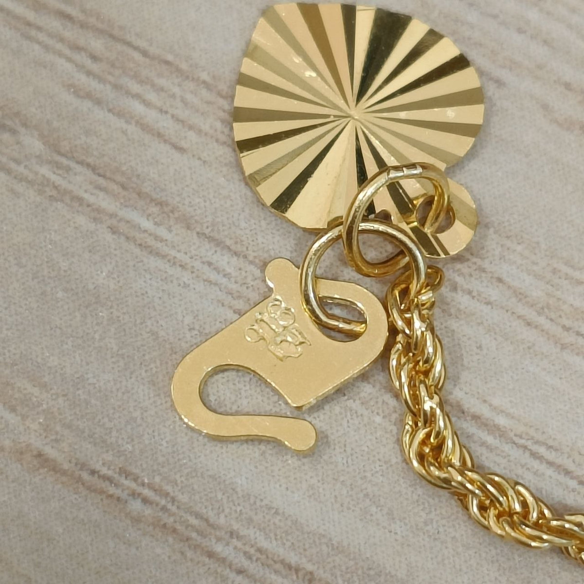 916 Gold hollow rope bracelet clasp and heart charm close-up