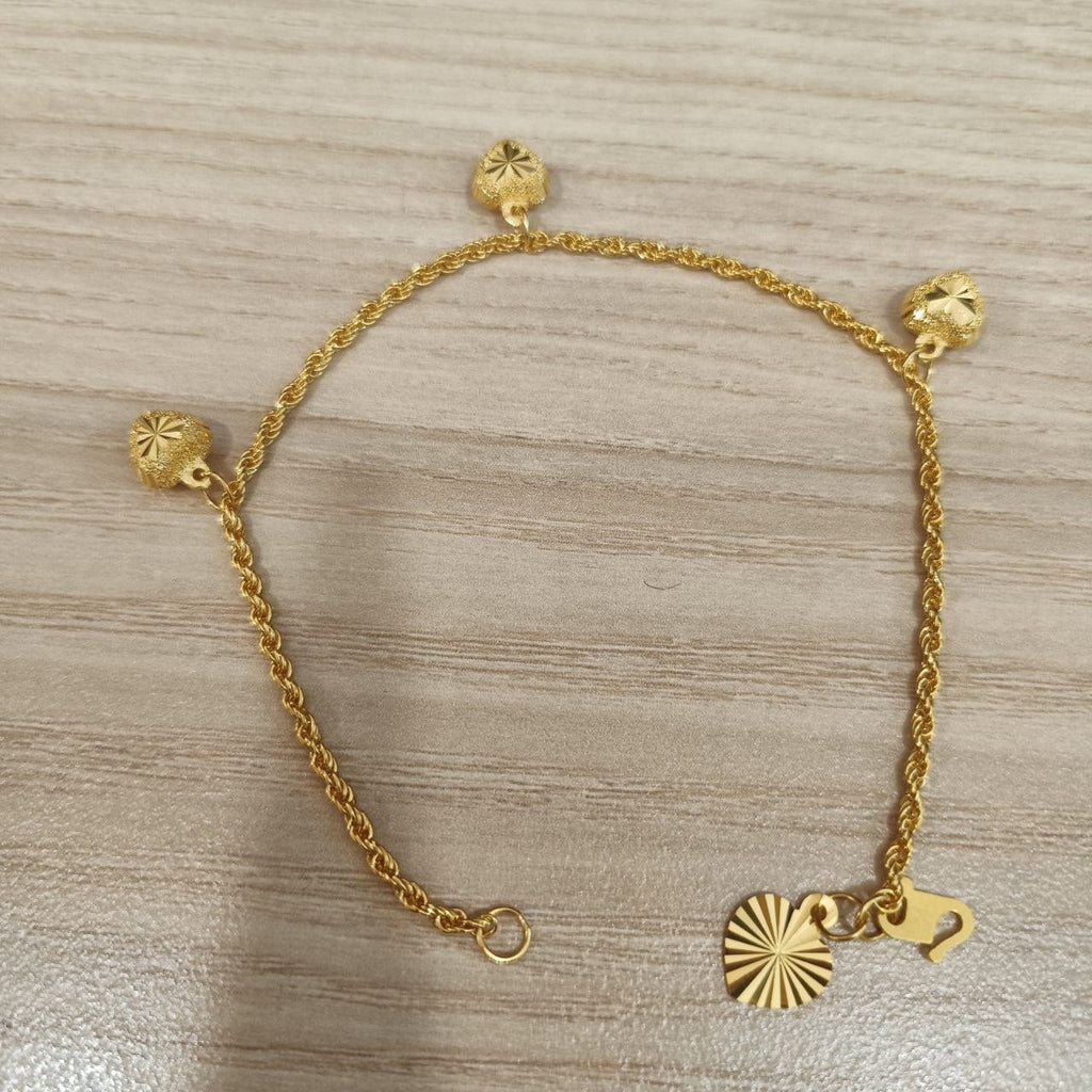916 Gold hollow rope bracelet showing heart charms and clasp