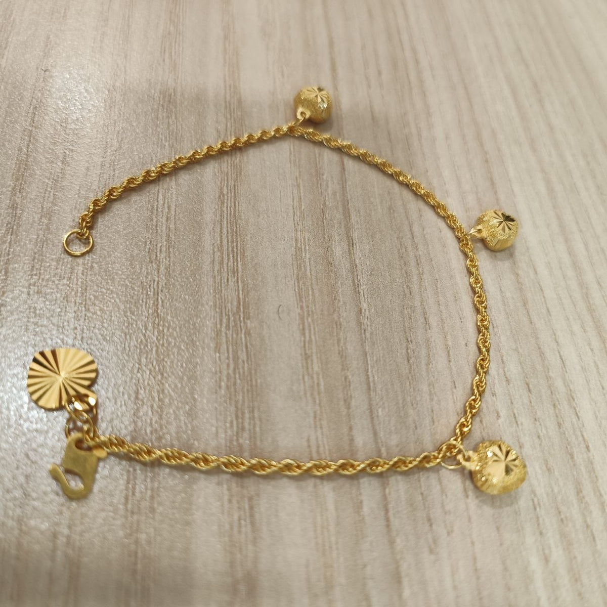 916 Gold hollow rope bracelet with three heart charms full view