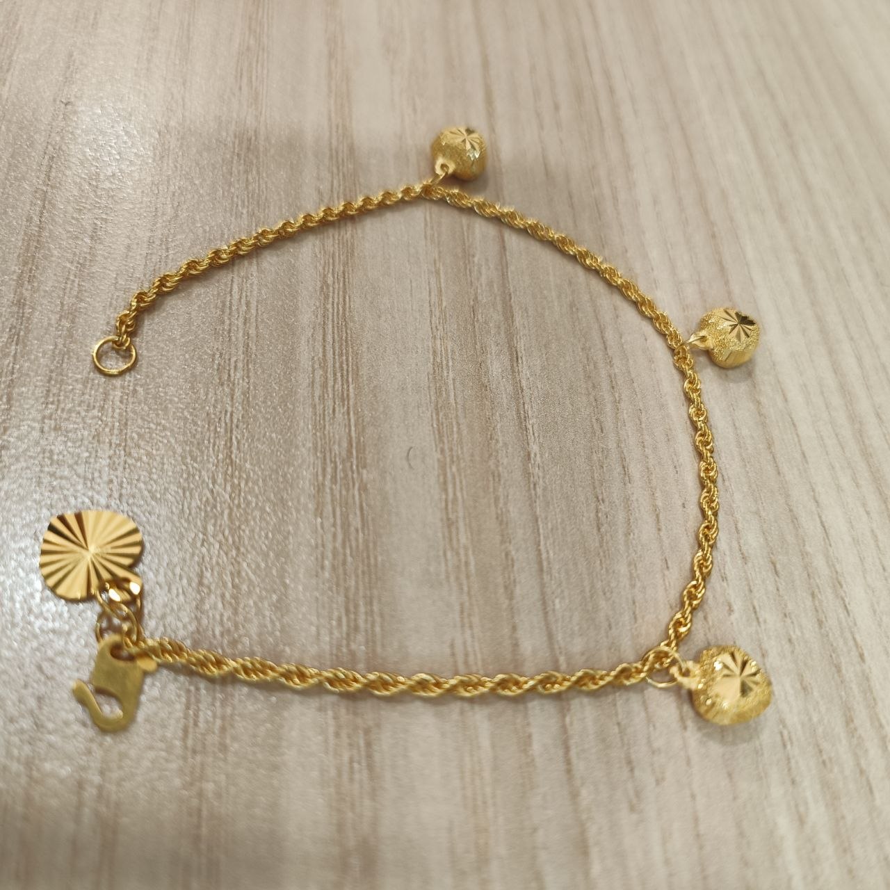 916 Gold hollow rope bracelet with three heart charms full view