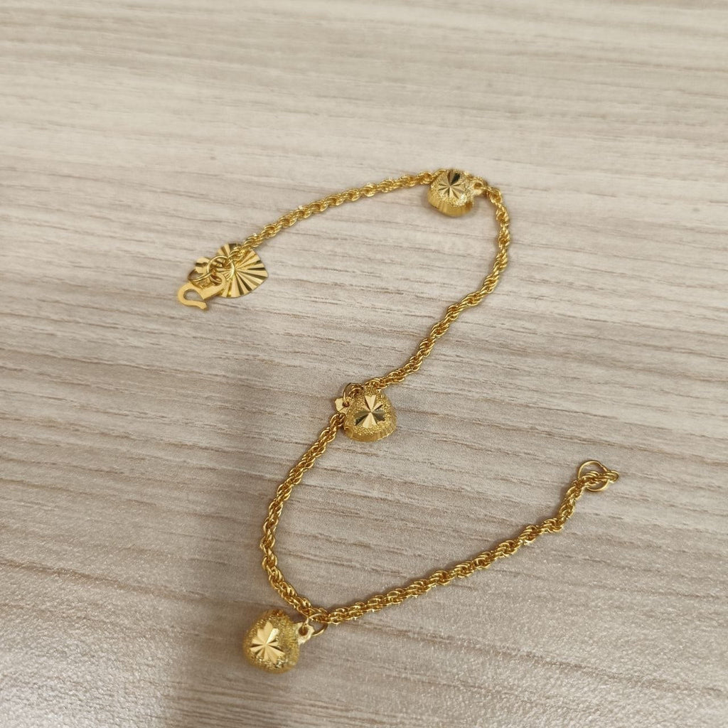 916 Gold hollow rope bracelet with dangling heart charms laid flat