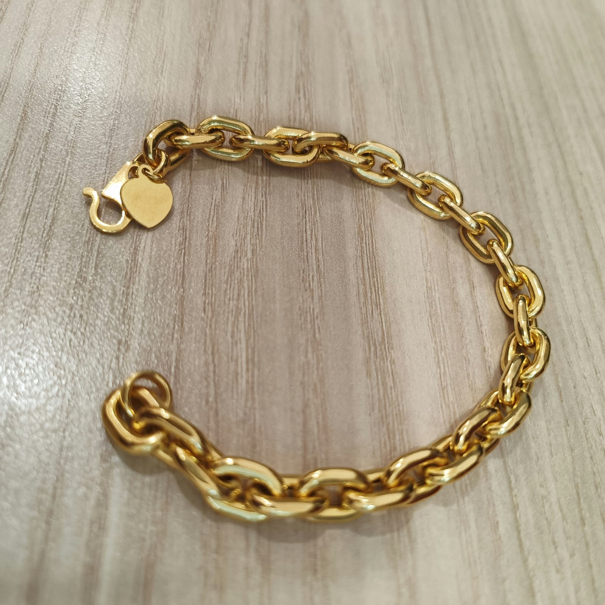 Angled view of heavier 916 gold hollow Wanzi bracelet