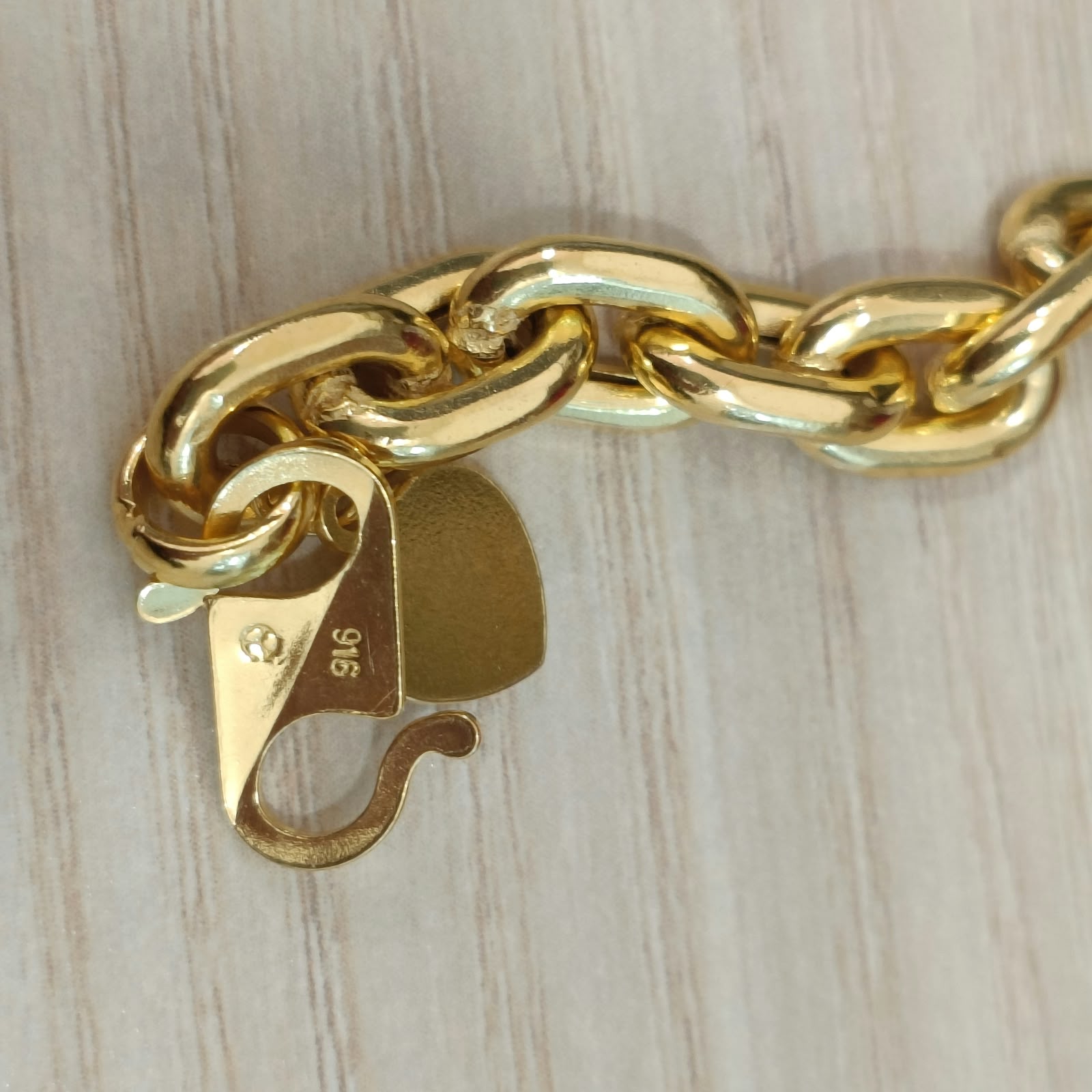 Full view of heavier 916 gold hollow Wanzi bracelet