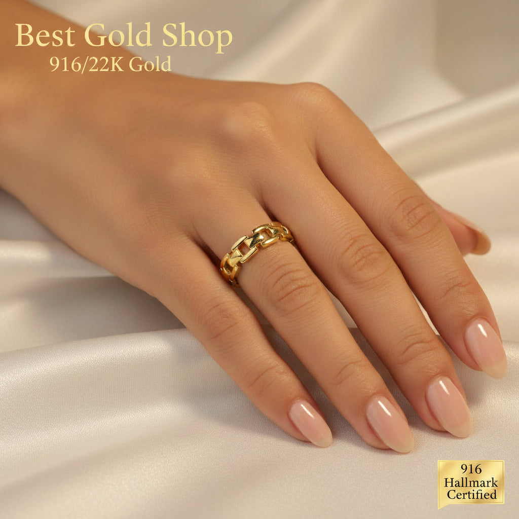 Side view of the lightweight 22K gold chain-link ring on white satin