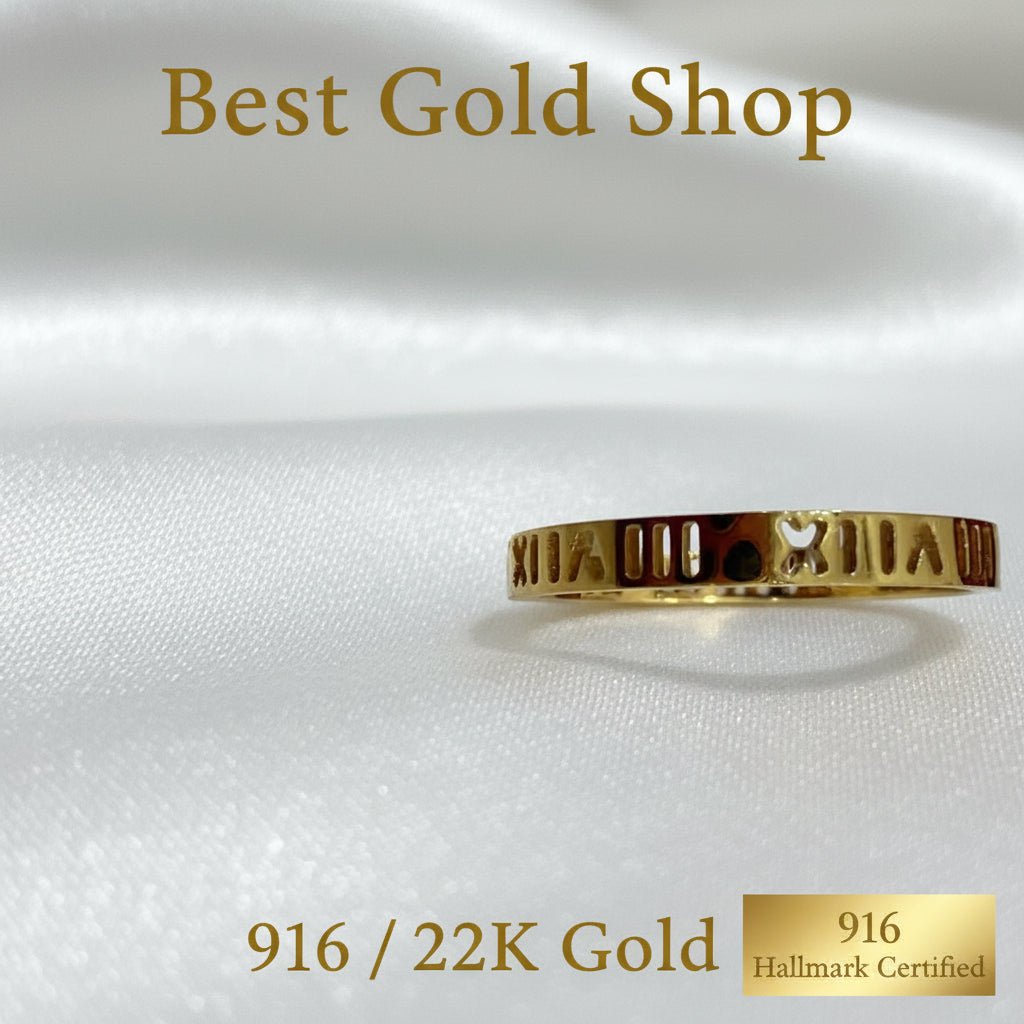 Mini Roman numeral gold ring with heart cutout detail on white fabric