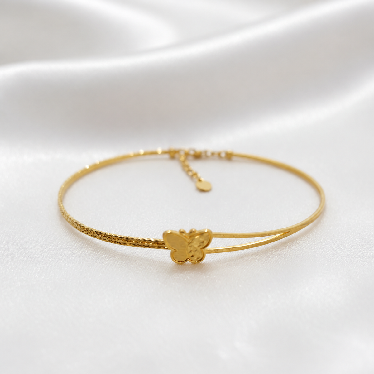 916 gold slim butterfly bangle on white satin