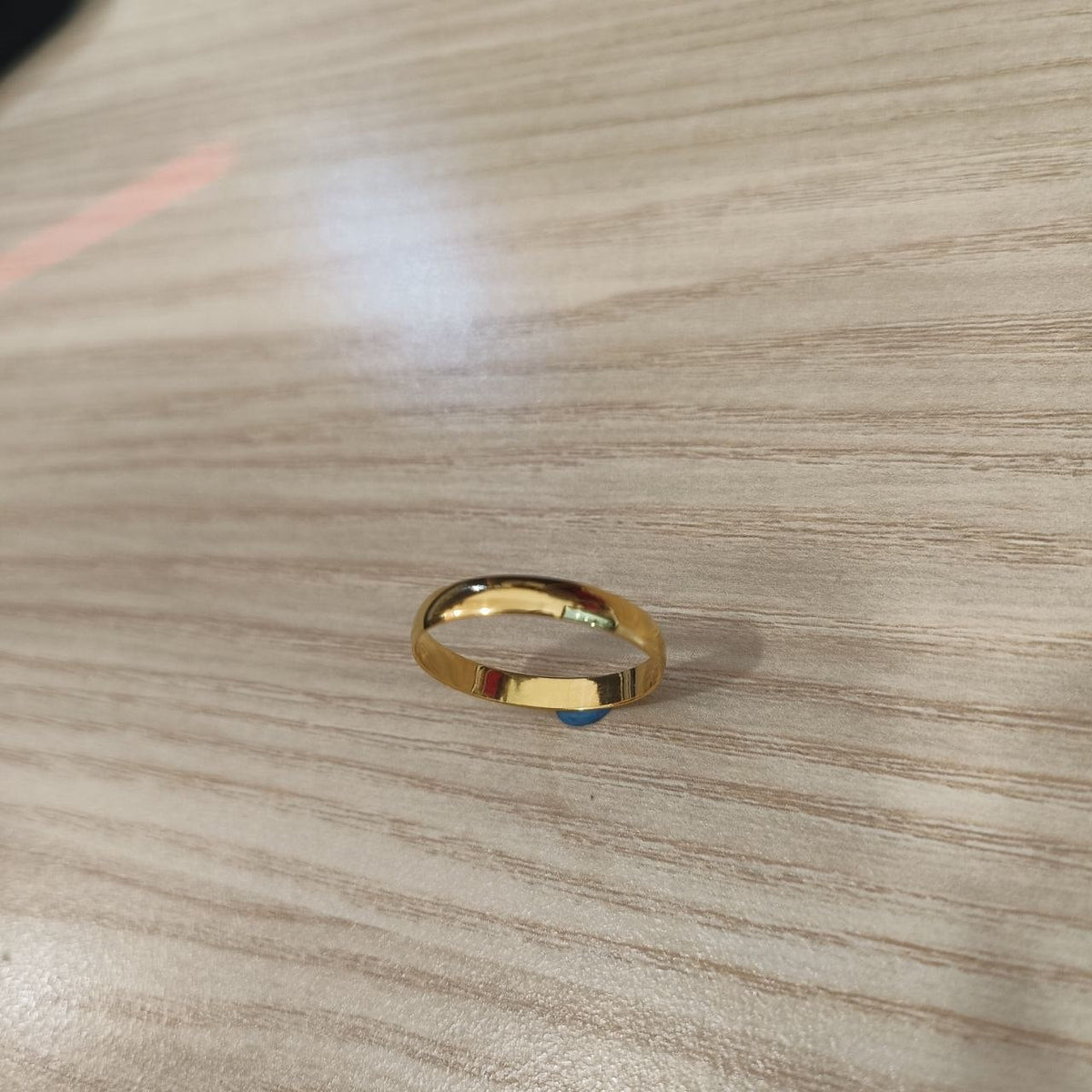 Angled view of 916 gold slim plain polished band ring