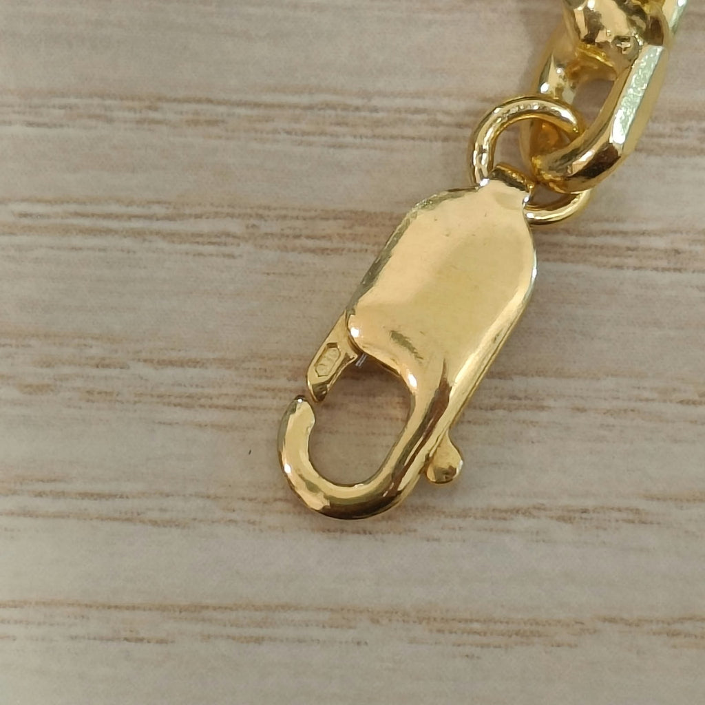 Close-up of polished 916 gold solid Wanzi bracelet links