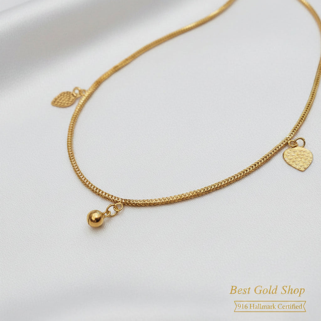916 gold anklet with textured heart charms and a bell