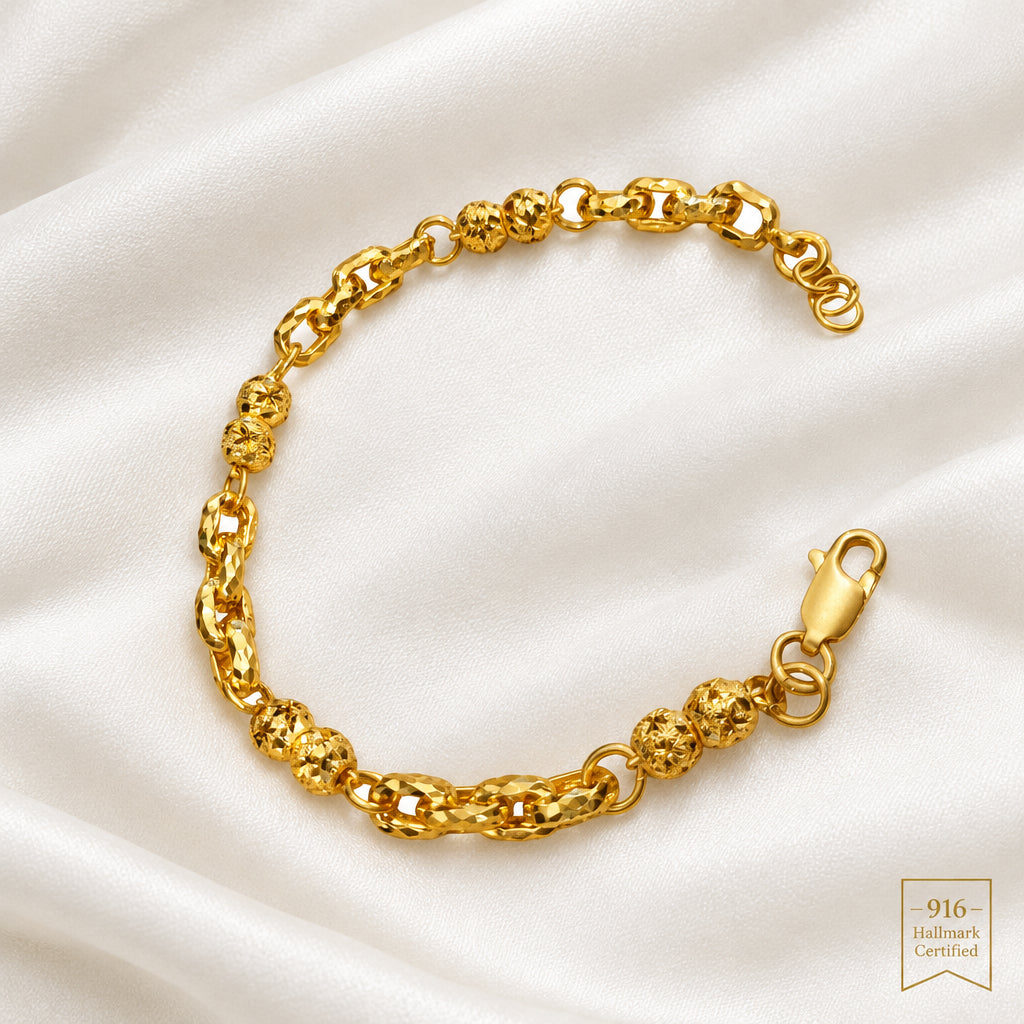916 gold Wan Zi ball bracelet on light fabric