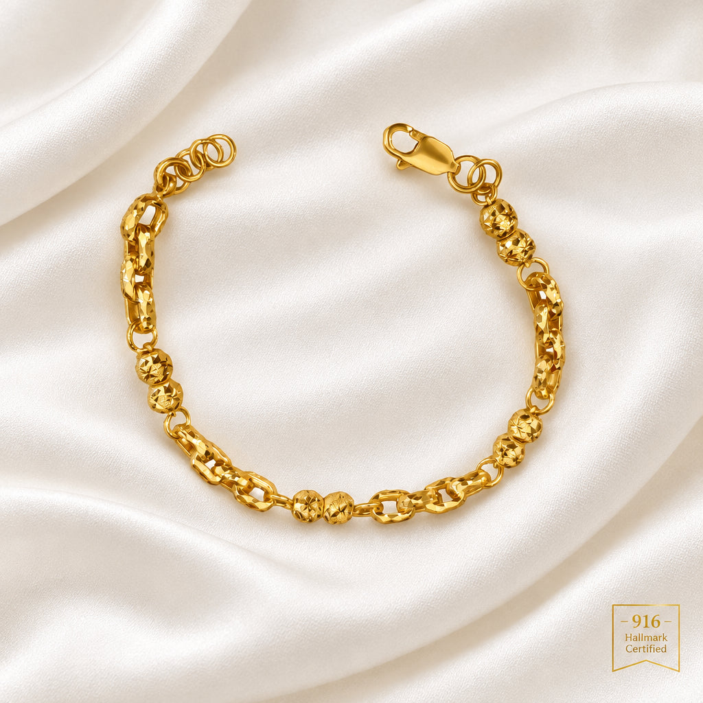 916 gold Wan Zi ball bracelet on light fabric