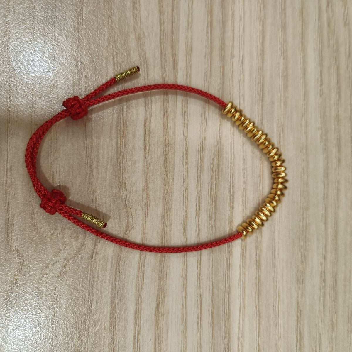 999 gold bead strand bracelet on red cord - alternate full view
