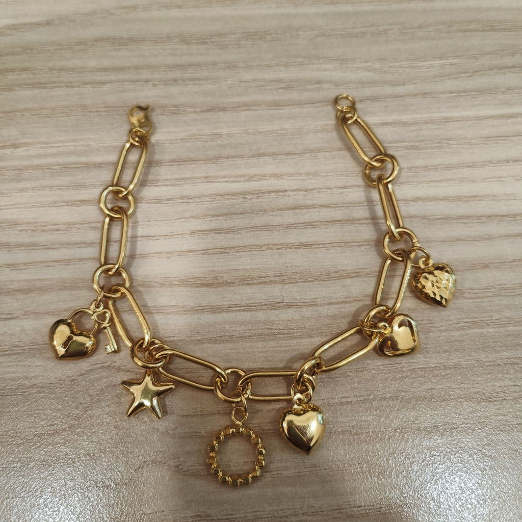 916 gold anchor bracelet with dangling charms laid flat, BR26764