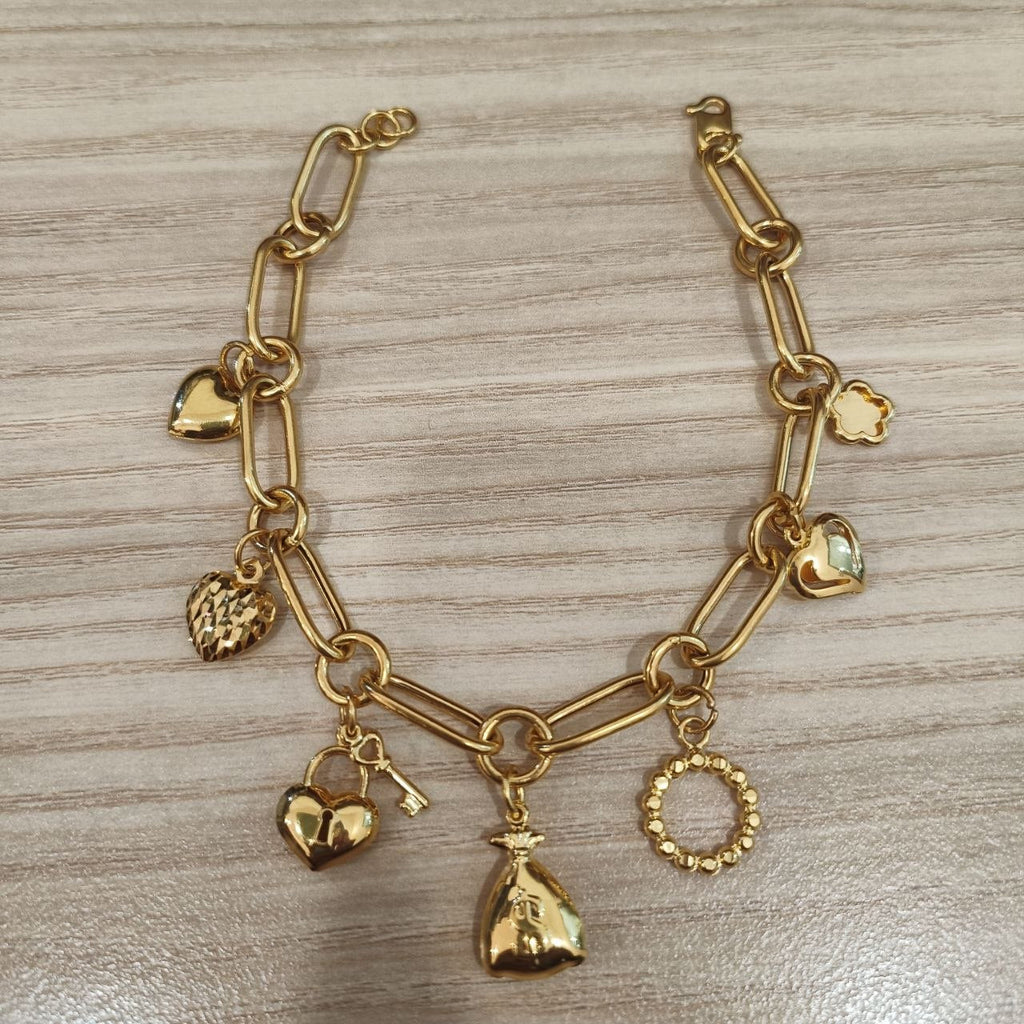 916 gold anchor bracelet with assorted charms laid flat, BR26765
