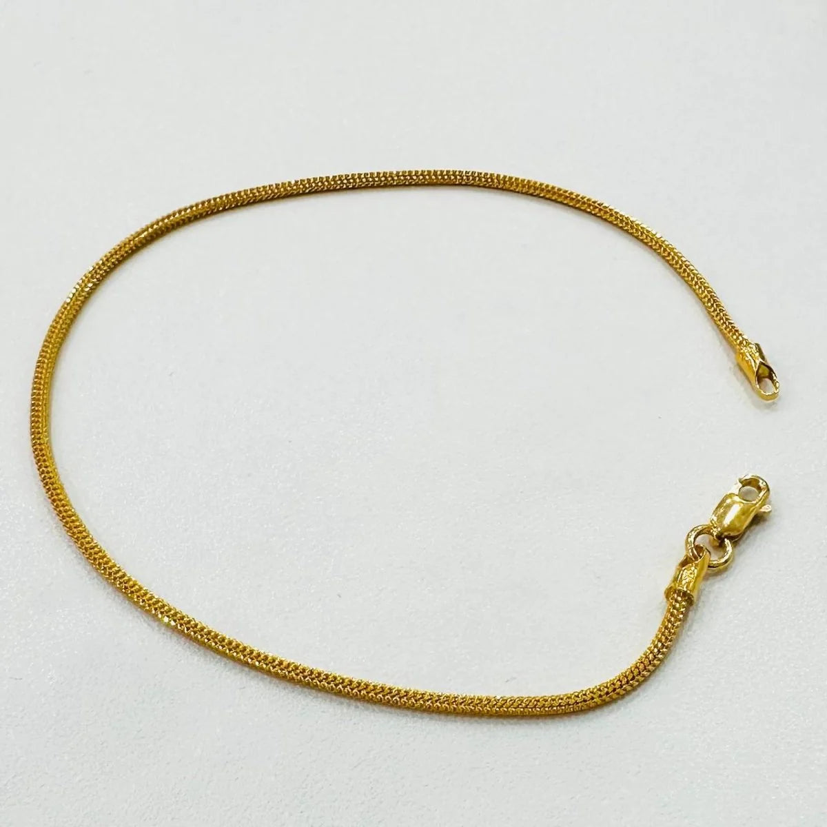 Original photo of the 4.44 g 916 gold dragon-link bracelet showing the full chain and lobster clasp