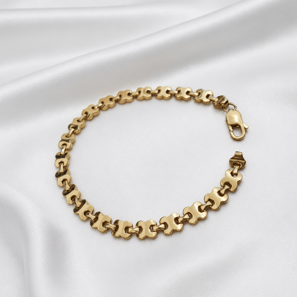 22K / 916 gold geometric-link bracelet laid open on satin, with lobster clasp and repeating links