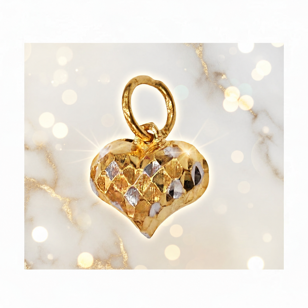 Front view of a faceted two-tone 916 gold heart pendant on a cream bokeh background