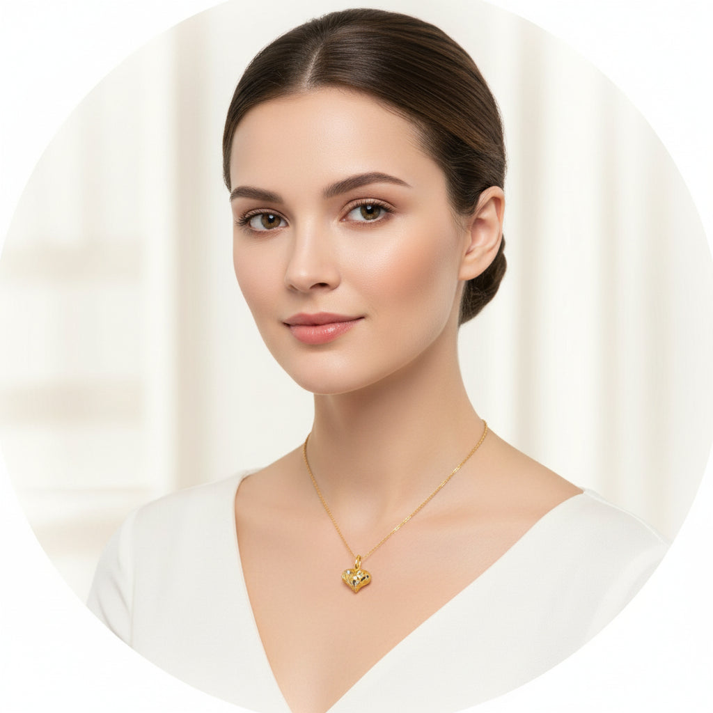 Model wearing a faceted two-tone 916 gold heart pendant on a fine chain