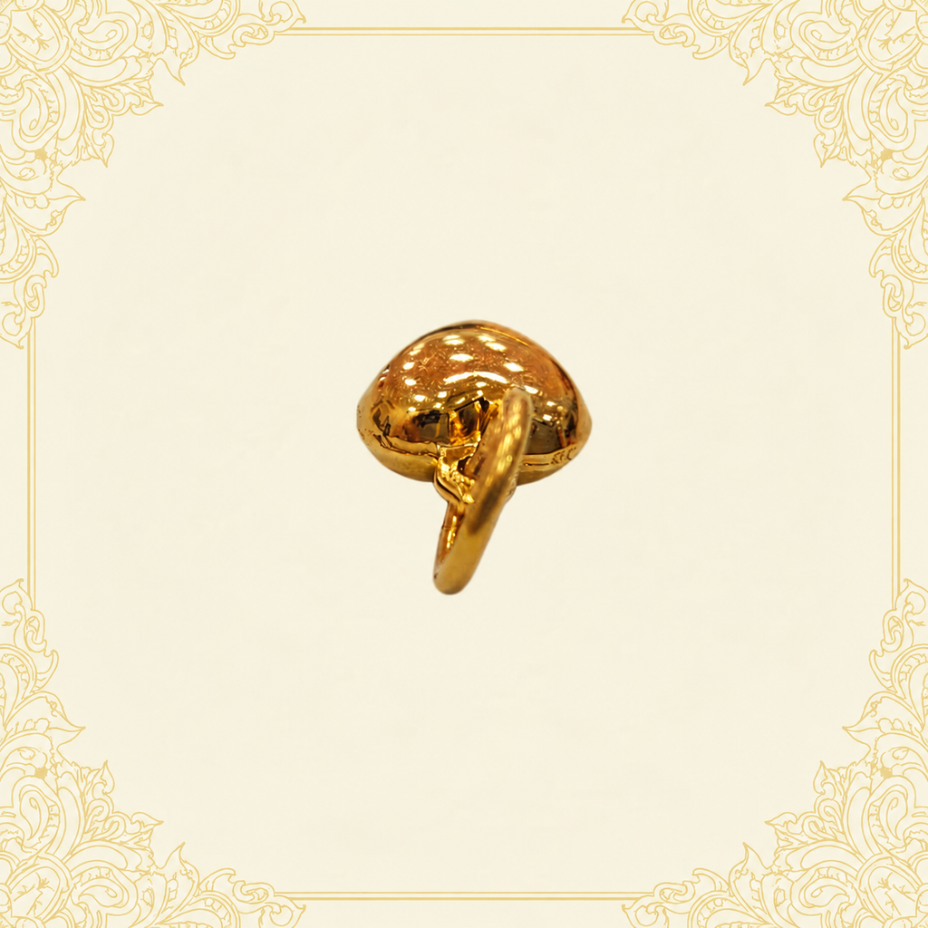 Reverse angle of a polished 916 gold heart pendant and its gold loop on cream