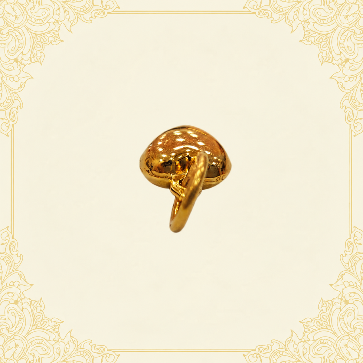 Reverse angle of a polished 916 gold heart pendant and its gold loop on cream