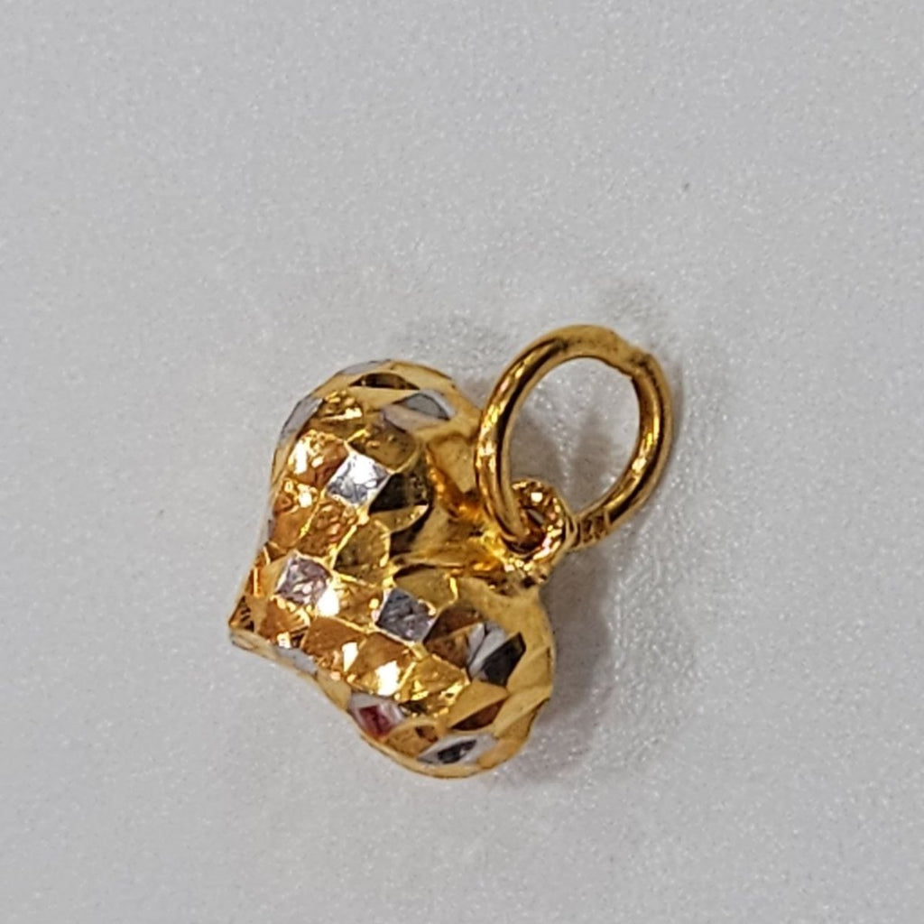 Faceted two-tone 916 gold heart pendant and gold loop on a grey textured surface