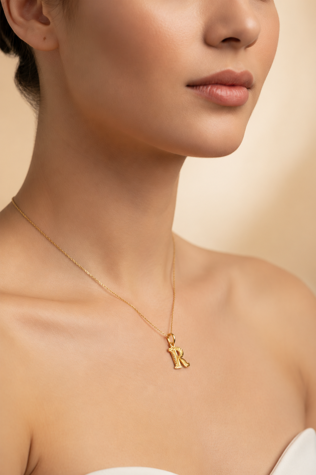 Guild Bullion 916 gold letter R pendant on a model for styling reference; chain not included