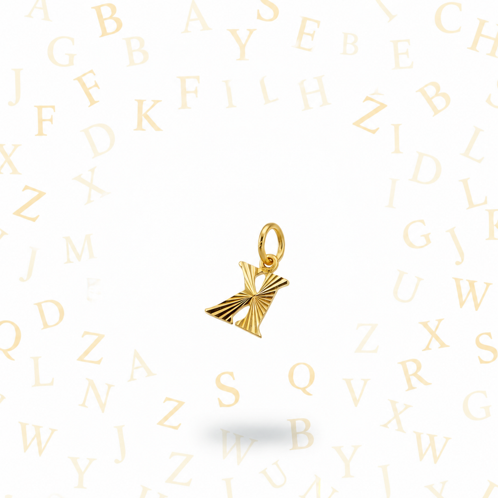Guild Bullion 916 gold letter K pendant in reverse orientation on an alphabet background