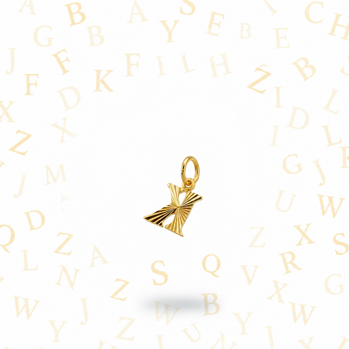 Guild Bullion 916 gold letter K pendant in reverse orientation on an alphabet background