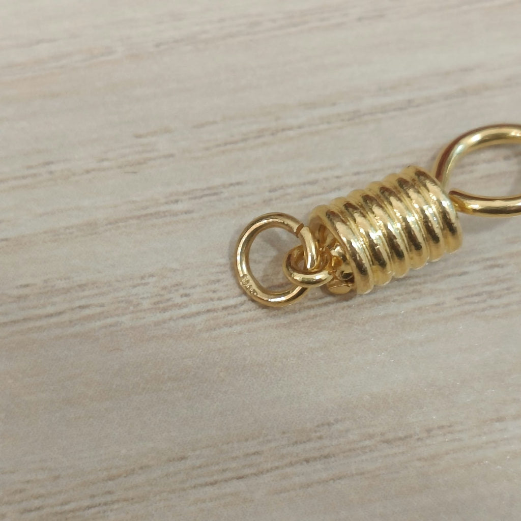 Close-up of connecting ring and ridged centre on 916 gold amulet hook PD30087