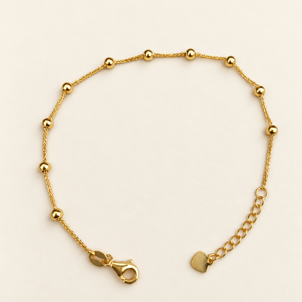 22K gold Fancy Bead Station Bracelet laid flat, showing spaced polished beads and adjustable extension