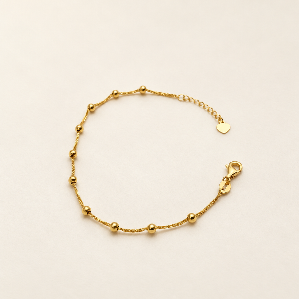 Full view of the 916 gold Fancy Bead Station Bracelet with polished beads, lobster clasp, extension chain and heart end tag