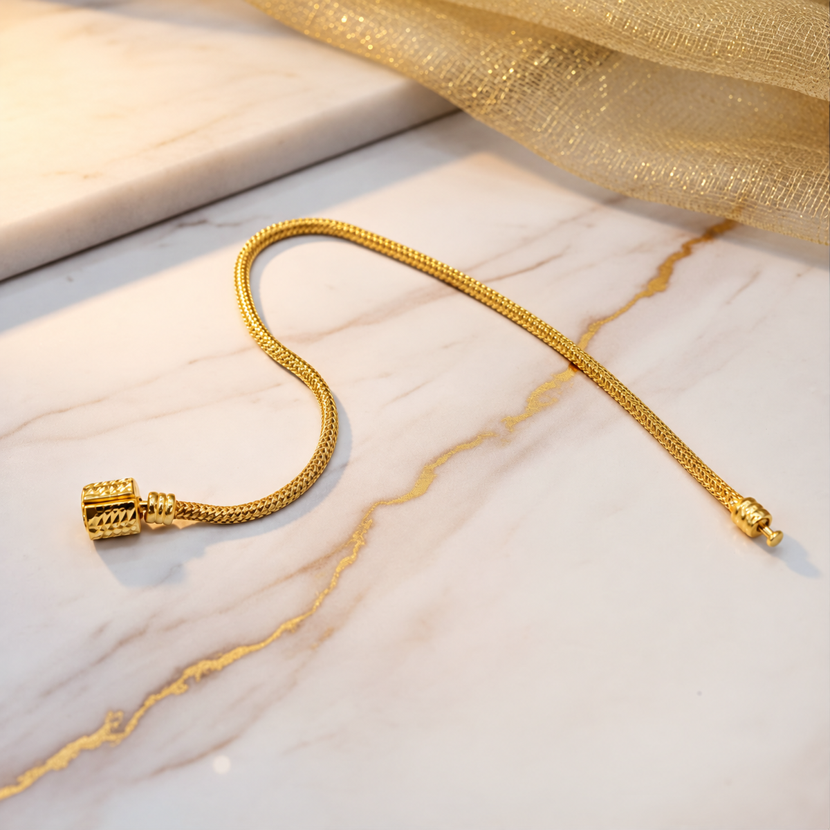Guild Bullion 22K / 916 gold Charm-Cut Bracelet with textured chain and decorative barrel clasp arranged on marble