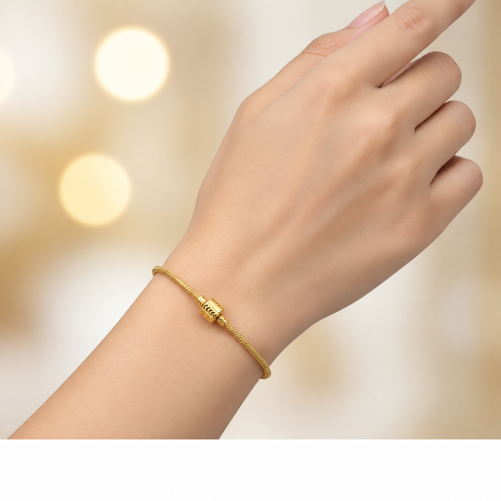 Guild Bullion 22K / 916 gold Charm-Cut Bracelet worn on a wrist showing its slim textured chain and cut-pattern barrel clasp