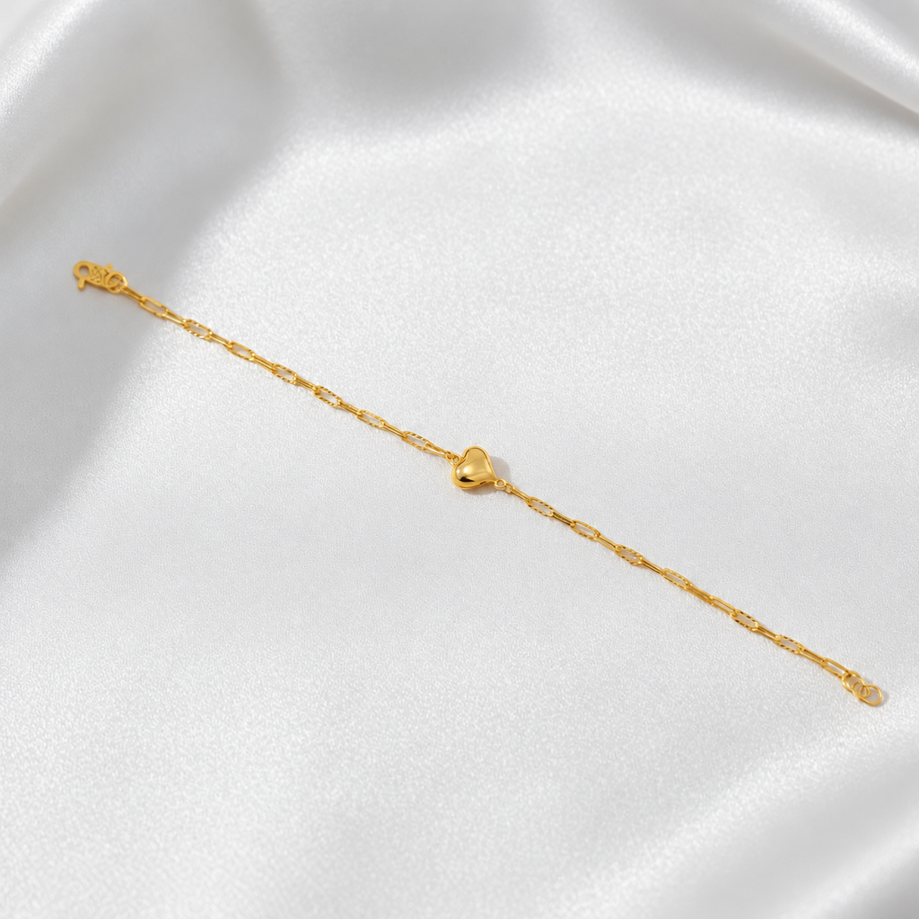 BR24467 916 gold Clip-Link Heart Bracelet shown at full length on white satin with polished heart, S-hook clasp and end rings