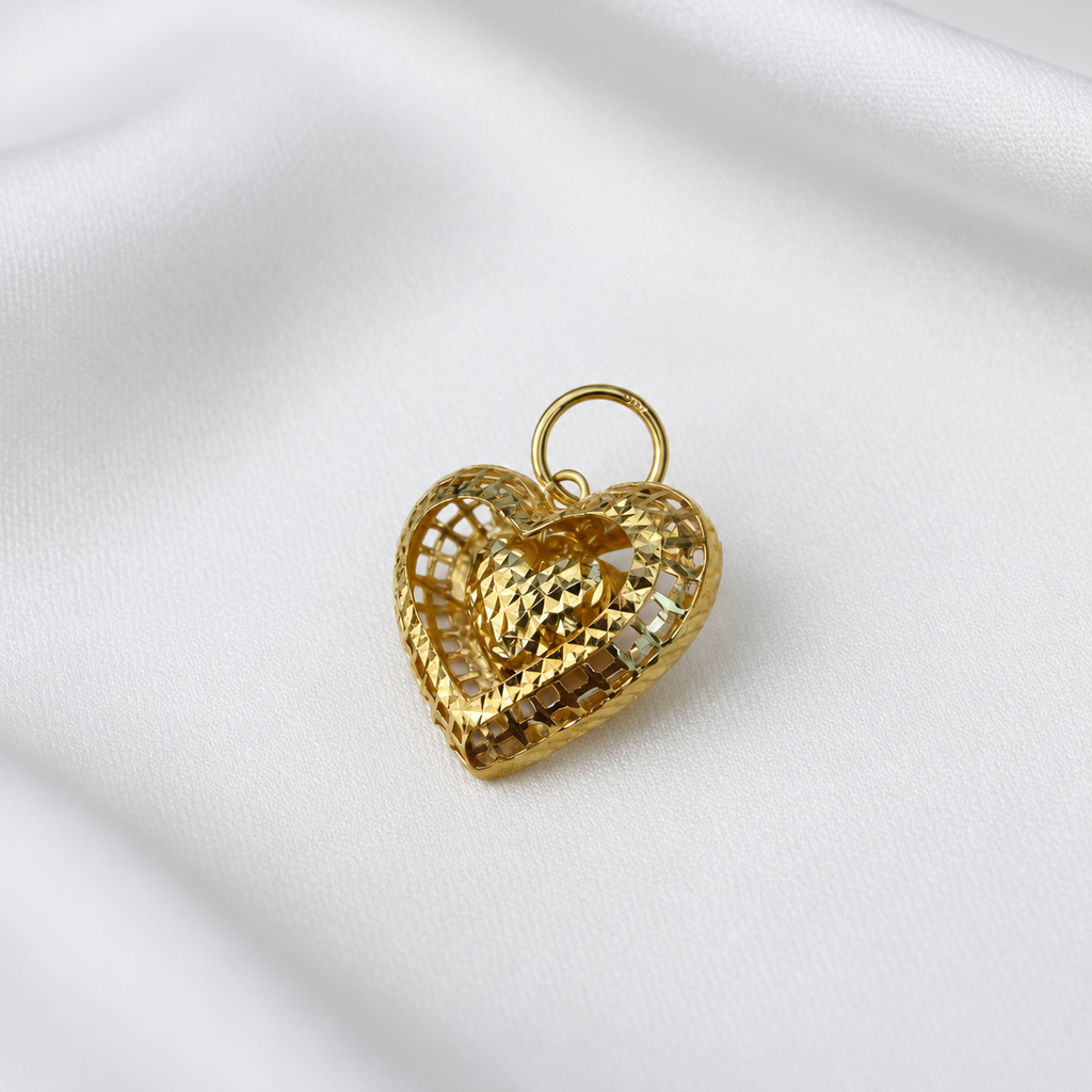 916 gold open heart pendant with a dangling faceted heart centre and round gold loop on white satin