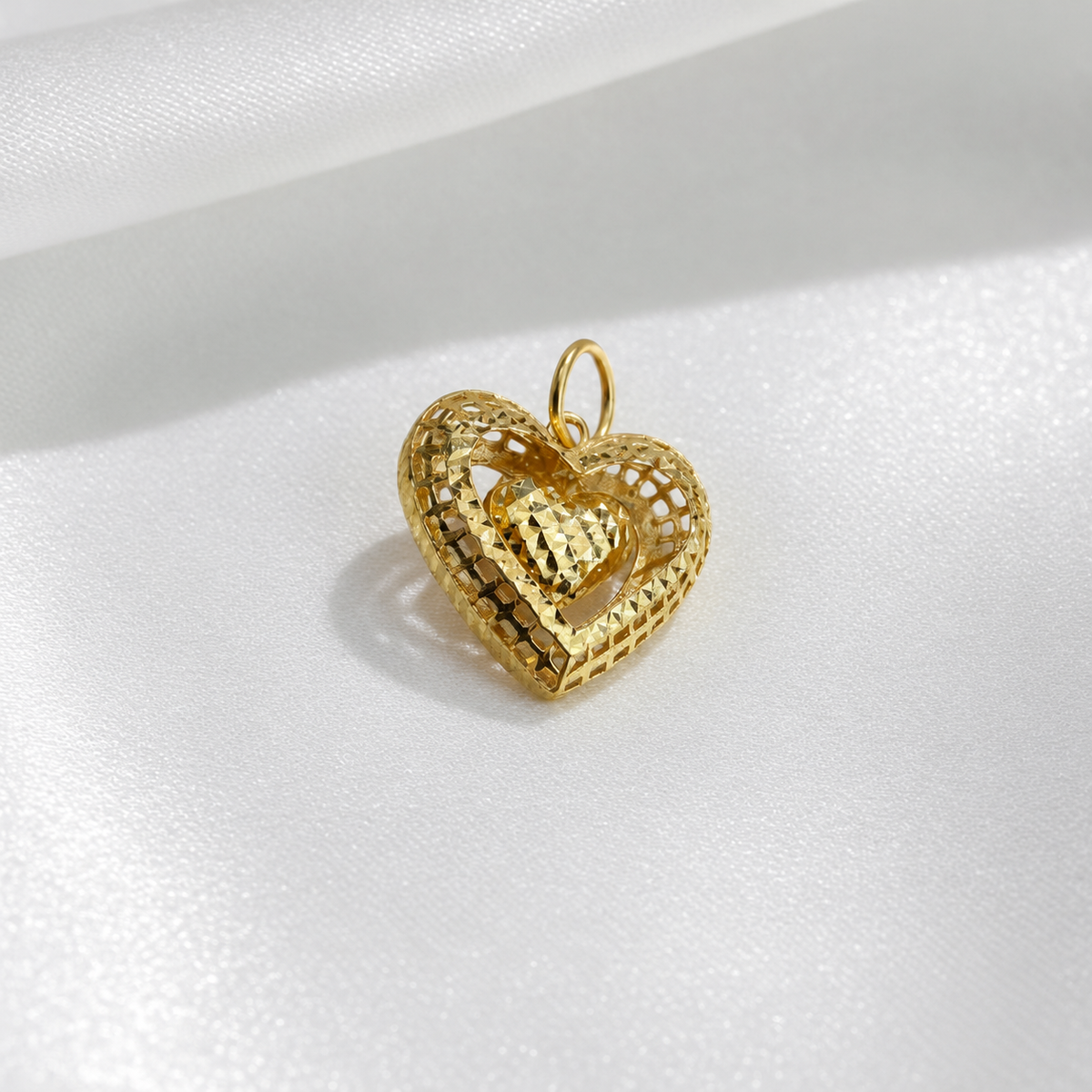 Angled view of the 916 gold dangling heart pendant showing the lattice frame and faceted inner heart