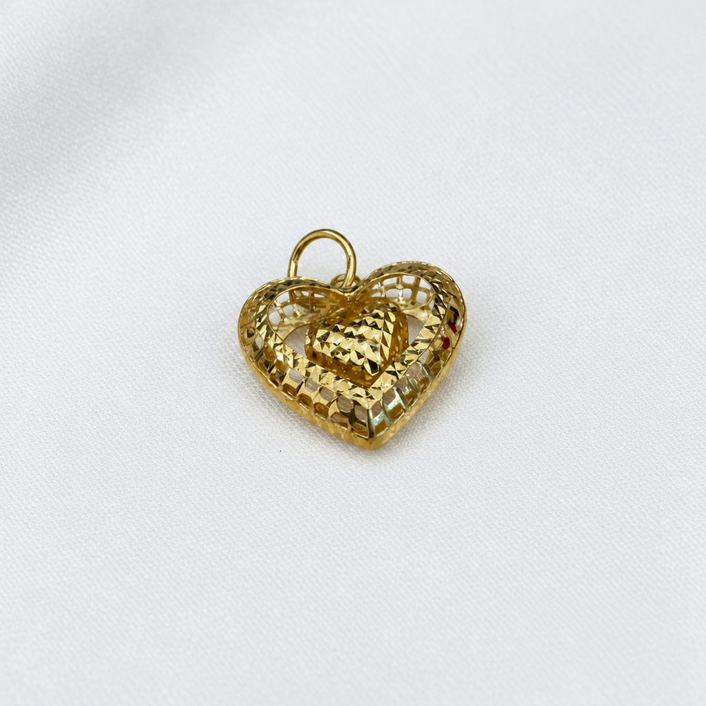 Close-up of the 916 gold dangling heart pendant showing textured open frame and faceted centre