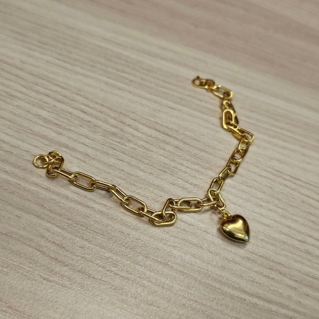 916 gold Dangling Heart Bracelet V2 BR25201 curved on wood with polished heart charm