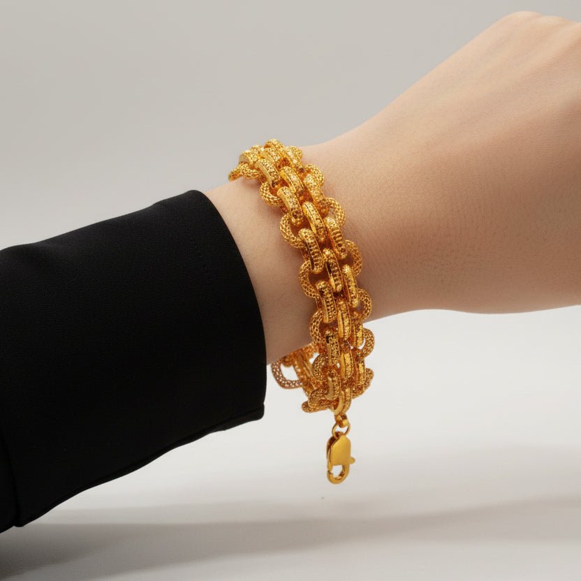916 gold double-link bracelet worn beside a black sleeve, showing the lobster clasp
