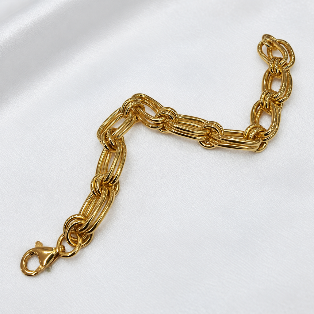 916 gold double link bracelet BR21575 with lobster clasp arranged diagonally on white satin