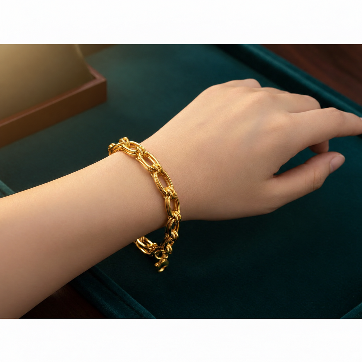 916 gold double link bracelet BR21575 worn on a wrist against dark green velvet