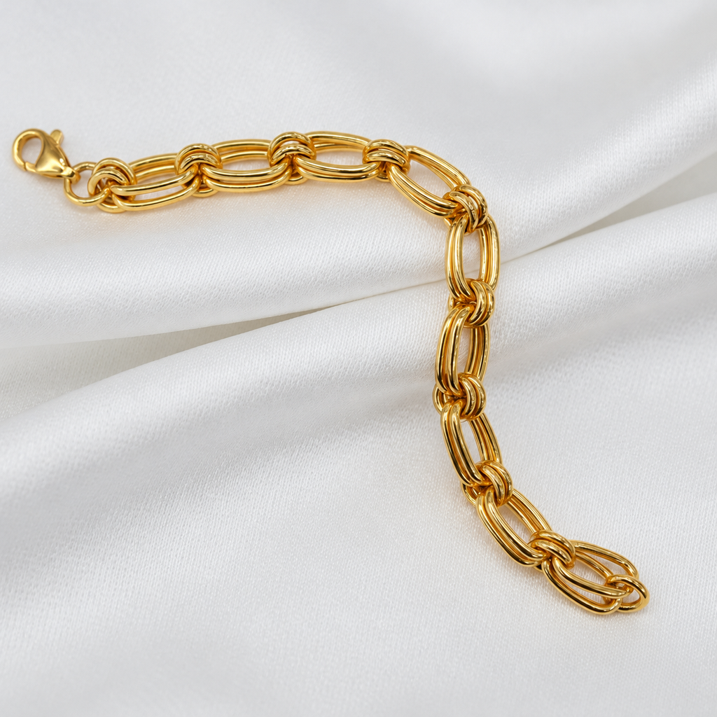 916 gold double link bracelet BR21575 draped across folded white satin