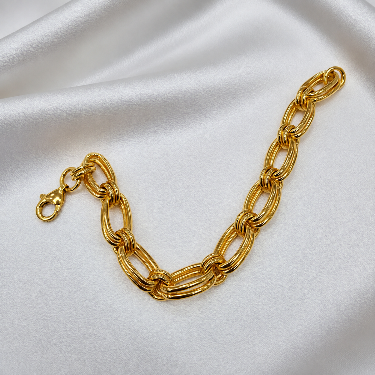 916 gold double link bracelet BR21575 arranged in a U shape on white satin